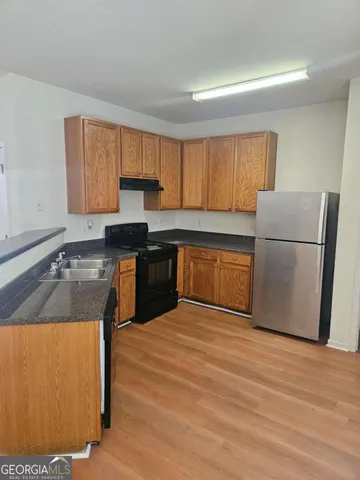 a kitchen with wooden cabinets and a sink