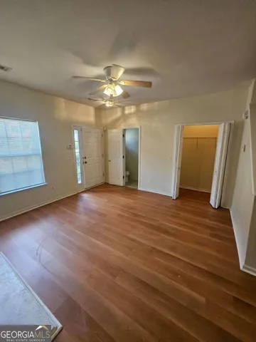 wooden floor in an empty room with a window
