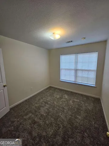 an empty room with a empty space and window