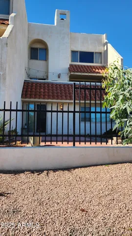 a view of building with large window and parking