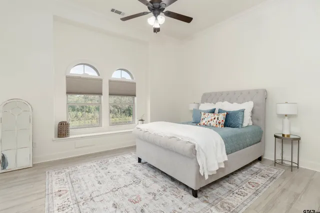 a bathroom with a granite countertop sink a toilet and shower