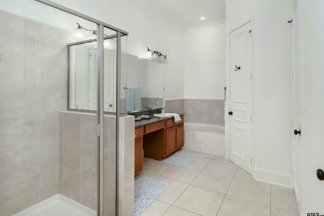 a bathroom with a granite countertop sink a toilet and mirror