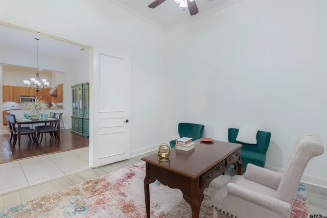 a view of a workspace with furniture and a window