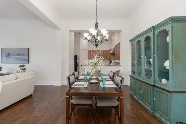 a kitchen with stainless steel appliances granite countertop a sink a stove a refrigerator and island with wooden cabinets