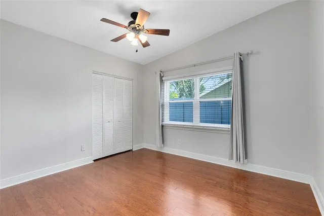 an empty room with windows and closet