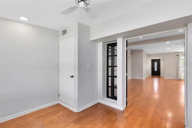 a view of a hallway with wooden floor