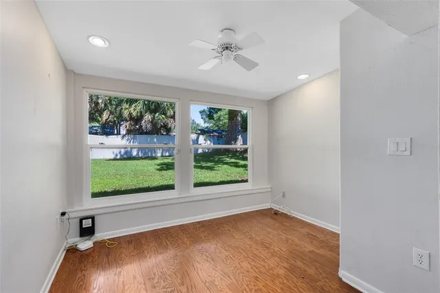 wooden floor in an empty room with a window