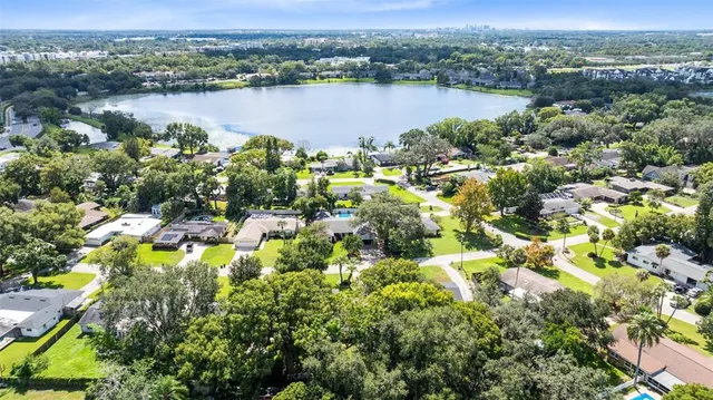 an aerial view of a houses with outdoor space and lake view