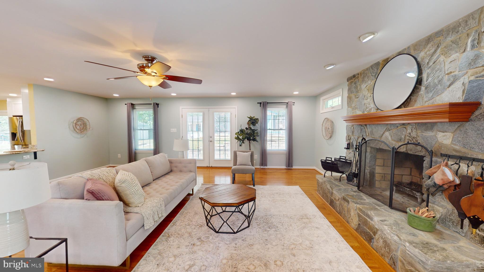 10600 Ward Road Dunkirk, MD 20754 - Photo 45 of 144 a living room with furniture a fireplace a rug and kitchen view