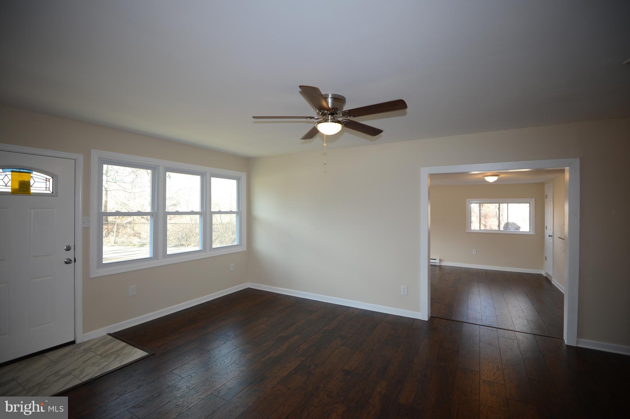 7500 Greenleaf Road Landover, MD 20785 - Photo 3 of 22 an empty room with wooden floor and windows