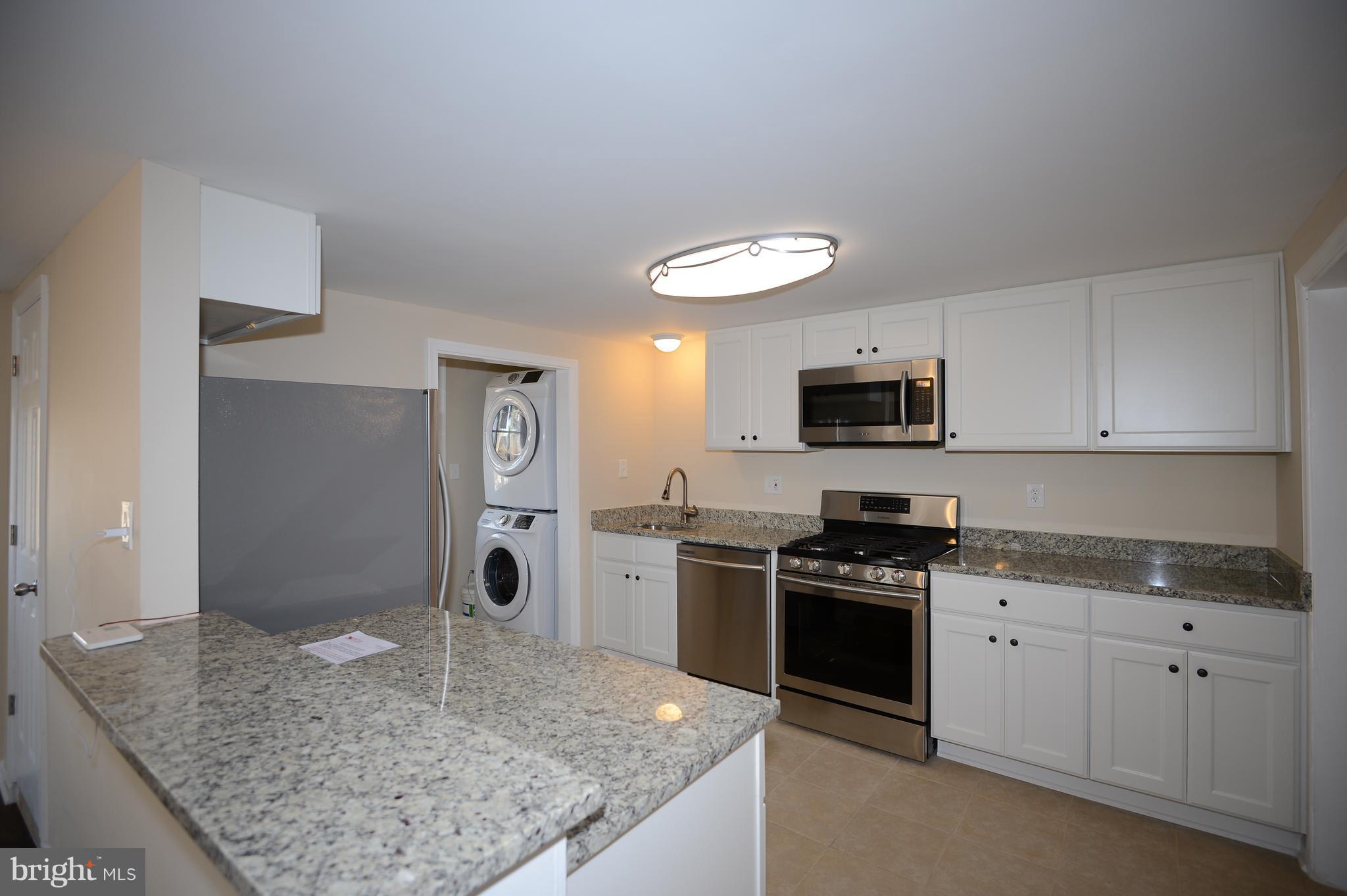 7500 Greenleaf Road Landover, MD 20785 - Photo 6 of 22 a kitchen with stainless steel appliances granite countertop a sink stove and cabinets