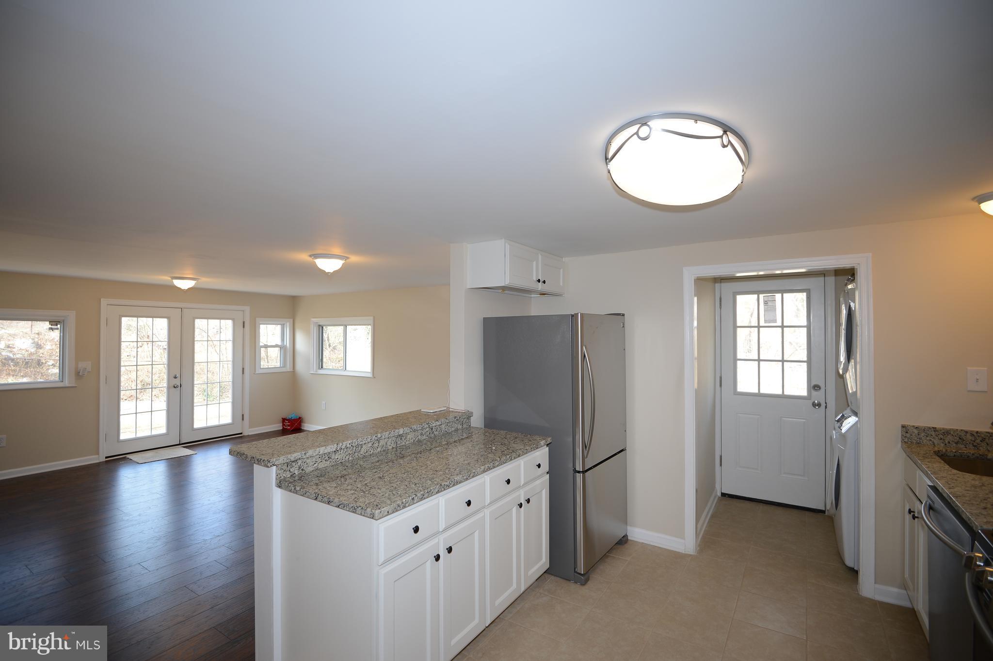 7500 Greenleaf Road Landover, MD 20785 - Photo 7 of 22 a kitchen with stainless steel appliances granite countertop a refrigerator a stove and a large window