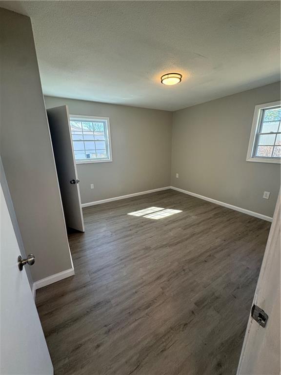 42 Busha Street Toccoa, GA 30577 - Photo 11 of 12 wooden floor in an empty room with a window