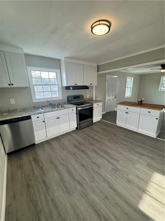 42 Busha Street Toccoa, GA 30577 - Photo 3 of 12 a large kitchen with a wooden floor and a stove top oven