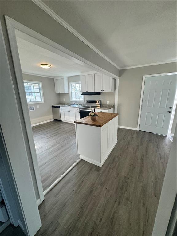 42 Busha Street Toccoa, GA 30577 - Photo 6 of 12 a kitchen with a sink a stove cabinets and a wooden floor