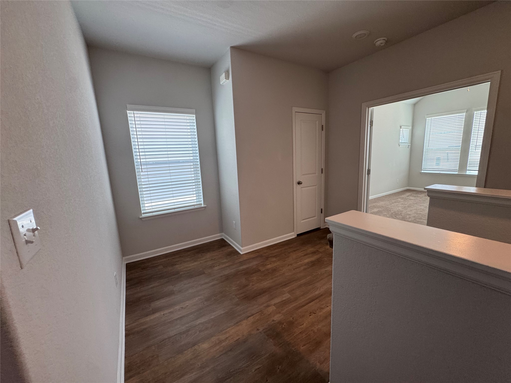 3000 Chisholm Trail Road, Unit 41 Round Rock, TX 78681 - Photo 24 of 28 Rich hardwood-style flooring extends from this adaptable landing, flowing into a nearby carpeted area.