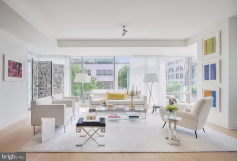 a living room with furniture and large windows