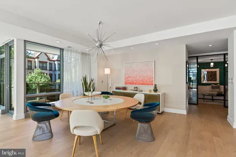 a large kitchen with kitchen island a large window a sink and stainless steel appliances