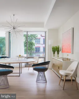 a living room with furniture a rug and a table