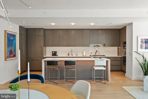 a living room with furniture a flat screen tv and a bookshelf