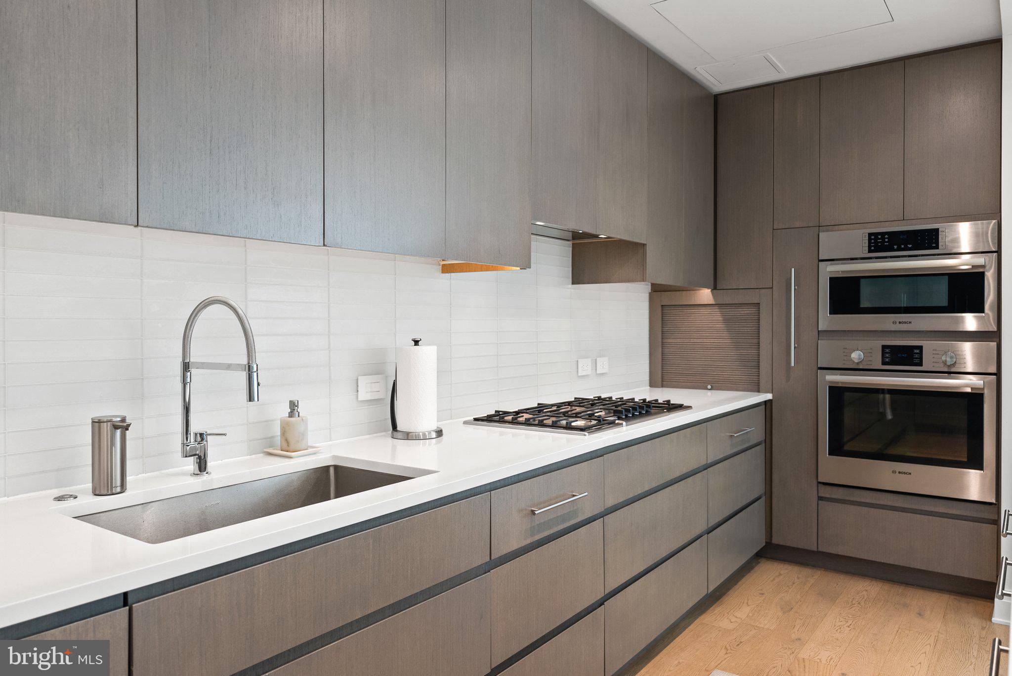 2501 M Street Northwest, Unit 203 Washington, DC 20037 - Photo 25 of 81 a kitchen with stainless steel appliances granite countertop a sink stove and microwave