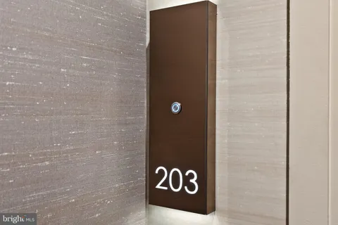 a living room with a table and a potted plant