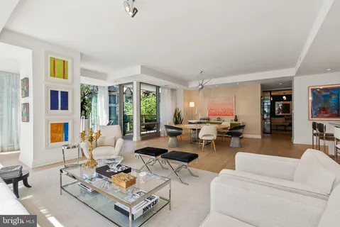 a bedroom with a large bed and a flat tv screen on dresser