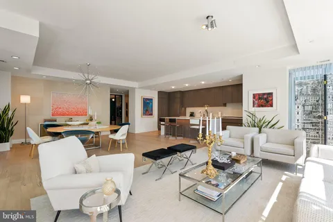 a living room with a fireplace furniture and a large window
