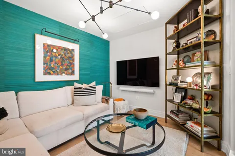 a bathroom with a toilet a sink a mirror and a shower