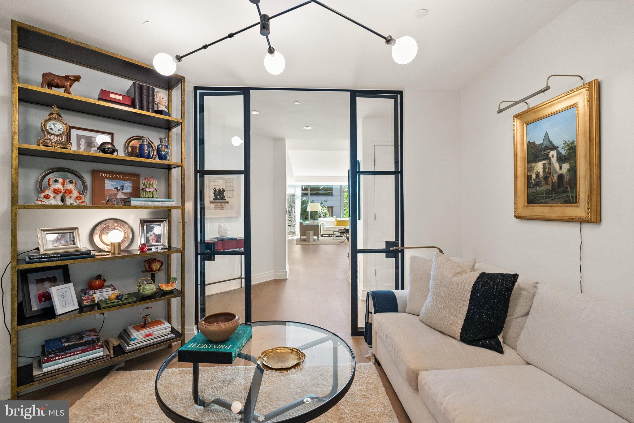 2501 M Street Northwest, Unit 203 Washington, DC 20037 - Photo 38 of 81 a living room with furniture cabinets and book shelf