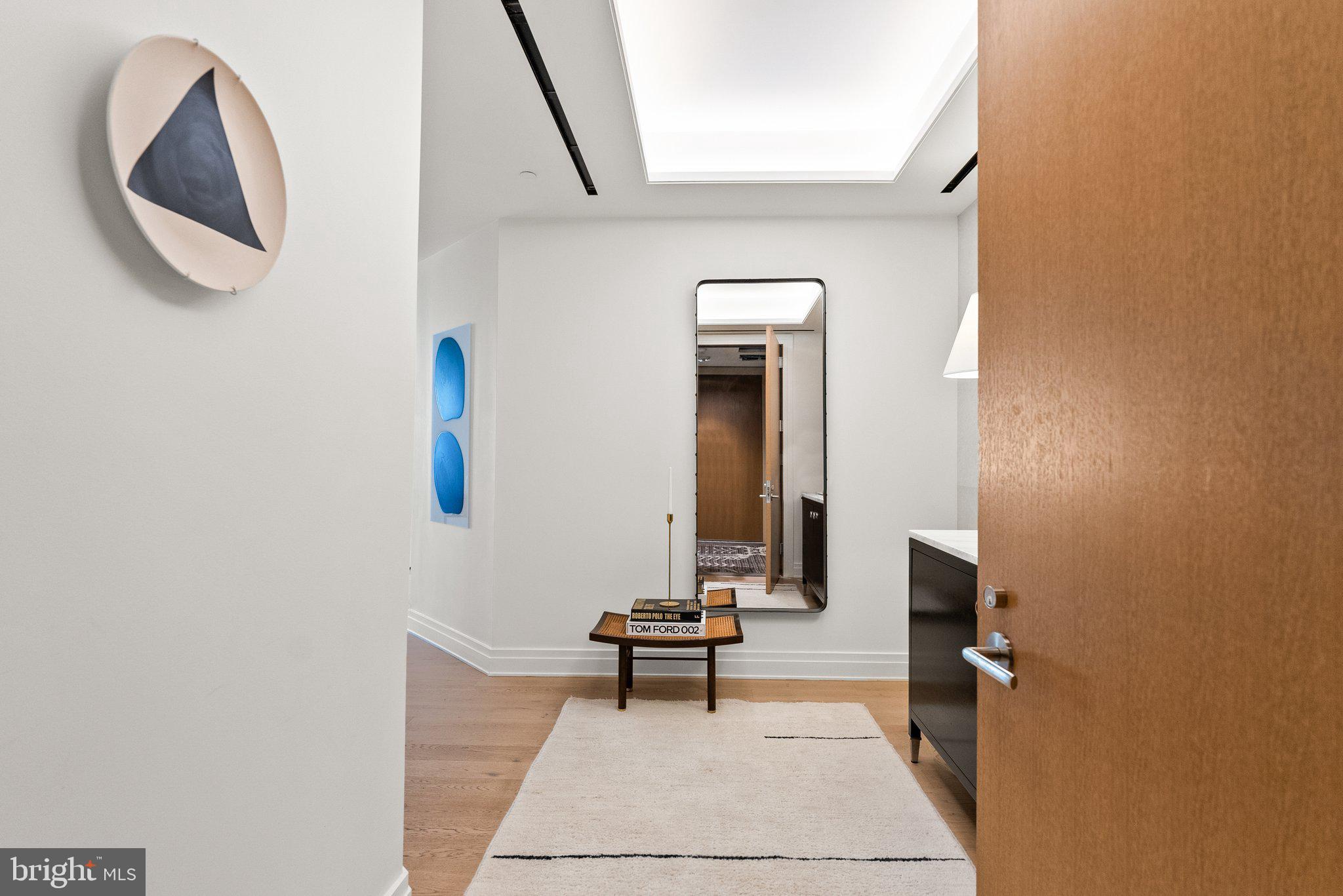 2501 M Street Northwest, Unit 203 Washington, DC 20037 - Photo 4 of 81 a living room with a table and a potted plant