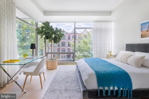 a living room with furniture a rug and a large window
