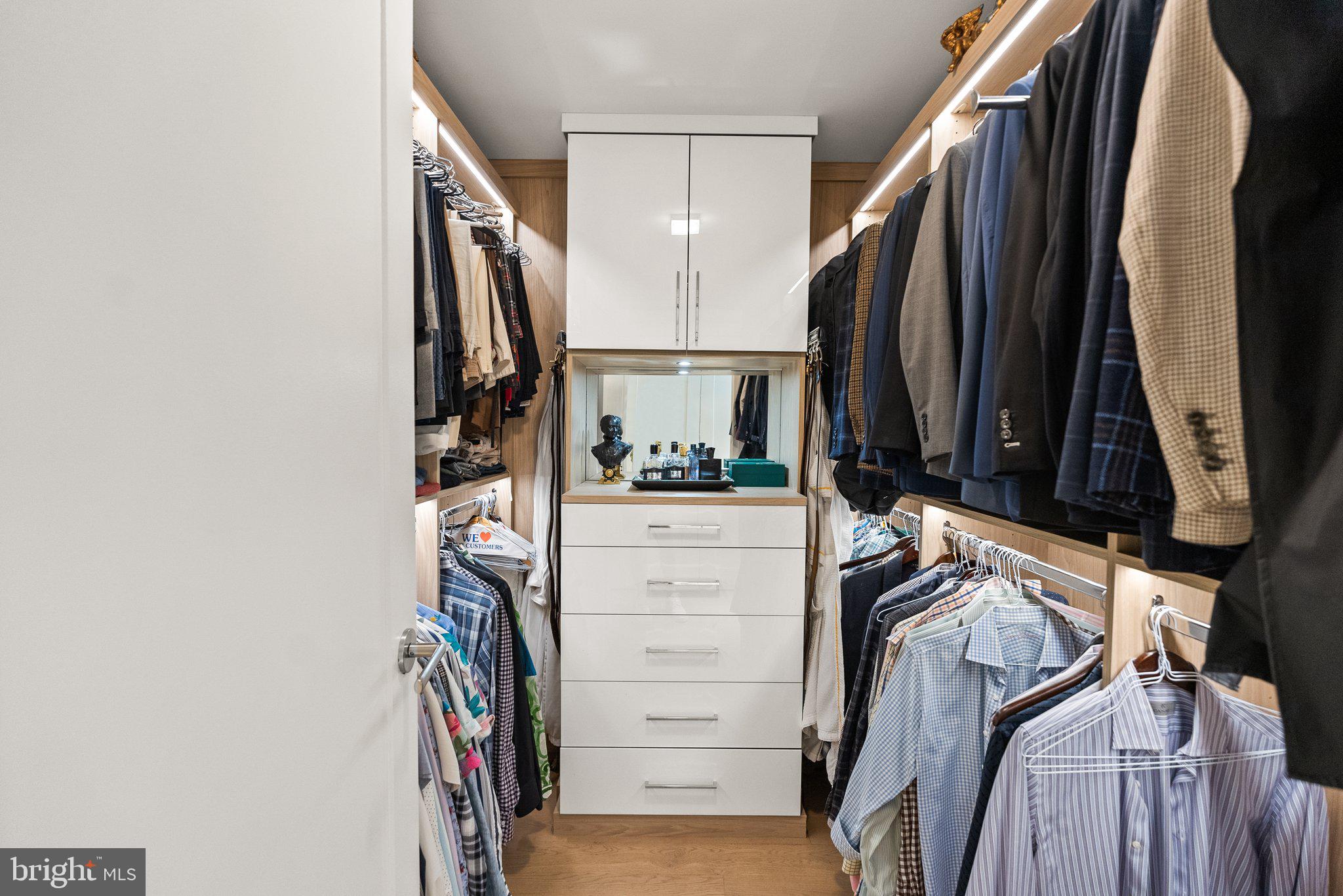 2501 M Street Northwest, Unit 203 Washington, DC 20037 - Photo 65 of 81 a view of walk in closet with clothes and shoes