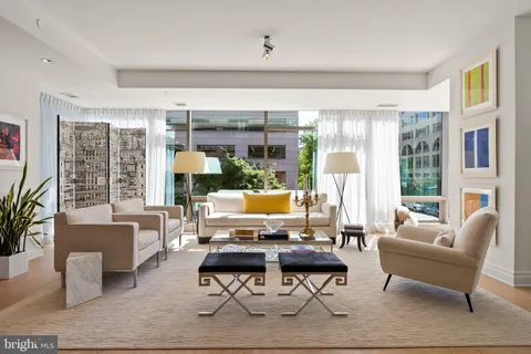 a dining room with furniture a chandelier and wooden floor