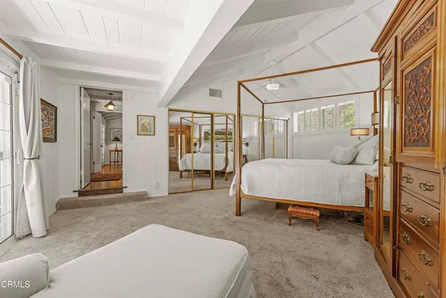 a spacious bathroom with a granite countertop sink a mirror and a shower