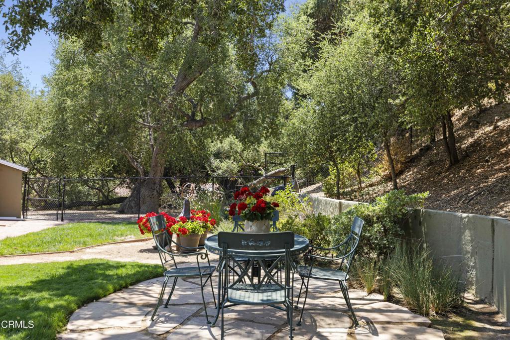 0 Stokes Canyon Road Calabasas, CA 91302 - Photo 43 of 52 a view of a table and chairs in backyard of the house