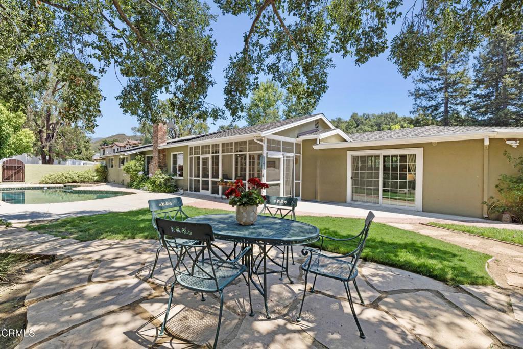 0 Stokes Canyon Road Calabasas, CA 91302 - Photo 44 of 52 a view of a patio with table and chairs with wooden fence and plants