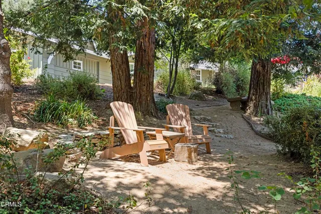 a view of a patio with table and chairs and potted plants