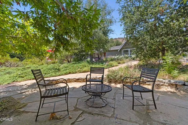 a view of a house with a tree in front
