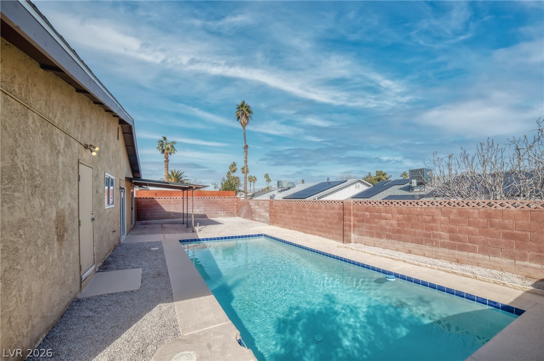3556 Ruth Drive Las Vegas, NV 89121 - Photo 19 of 21 A private, rectangular swimming pool awaits, surrounded by a durable block fence and a pebbled border.