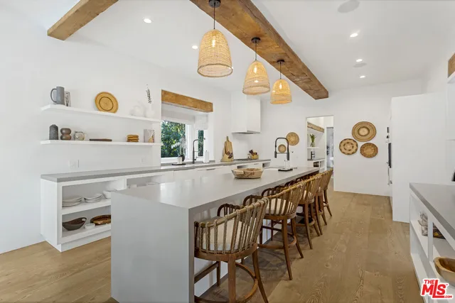 a kitchen with a sink a stove and chairs