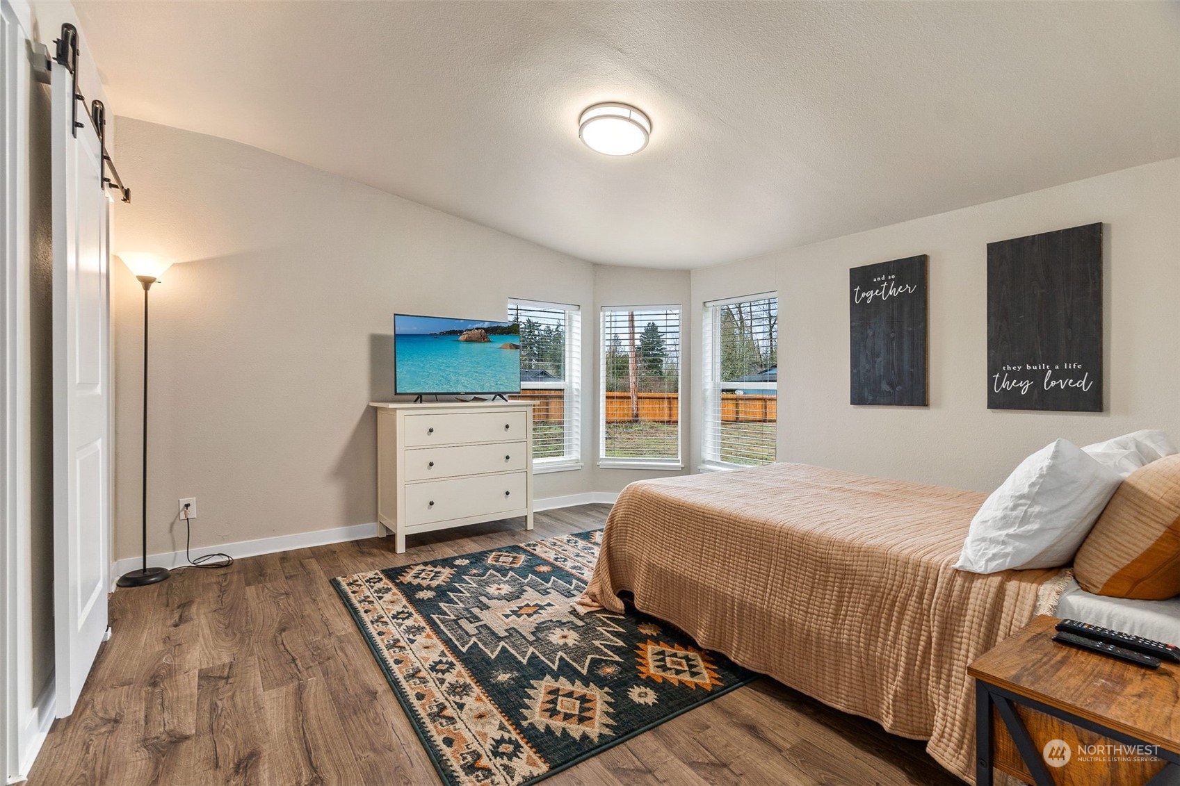 19025 Marble Street Southwest Rochester, WA 98579 - Photo 13 of 26 a bedroom with a bed and wooden floor