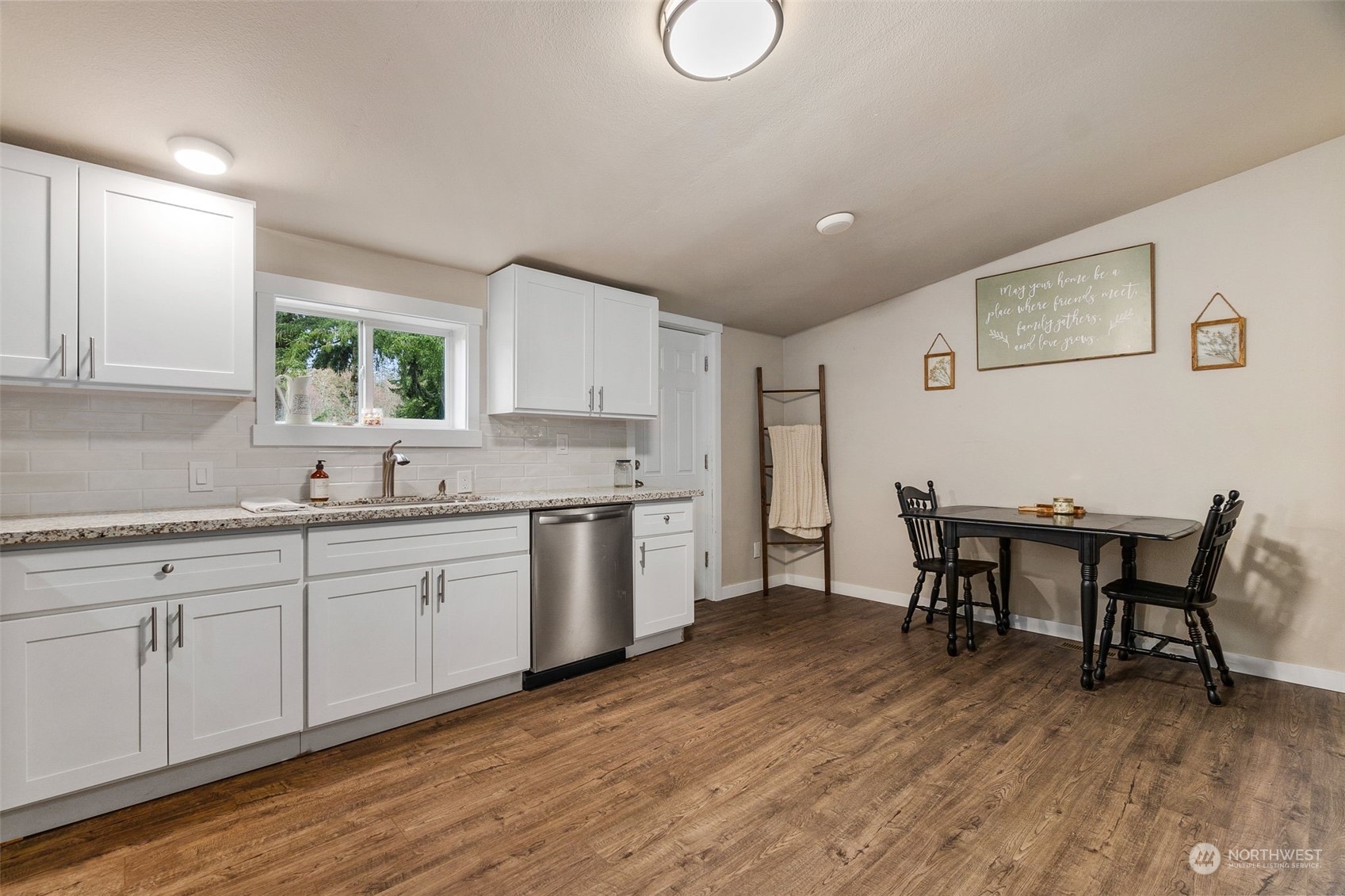 19025 Marble Street Southwest Rochester, WA 98579 - Photo 16 of 26 a kitchen with a table chairs sink and cabinets