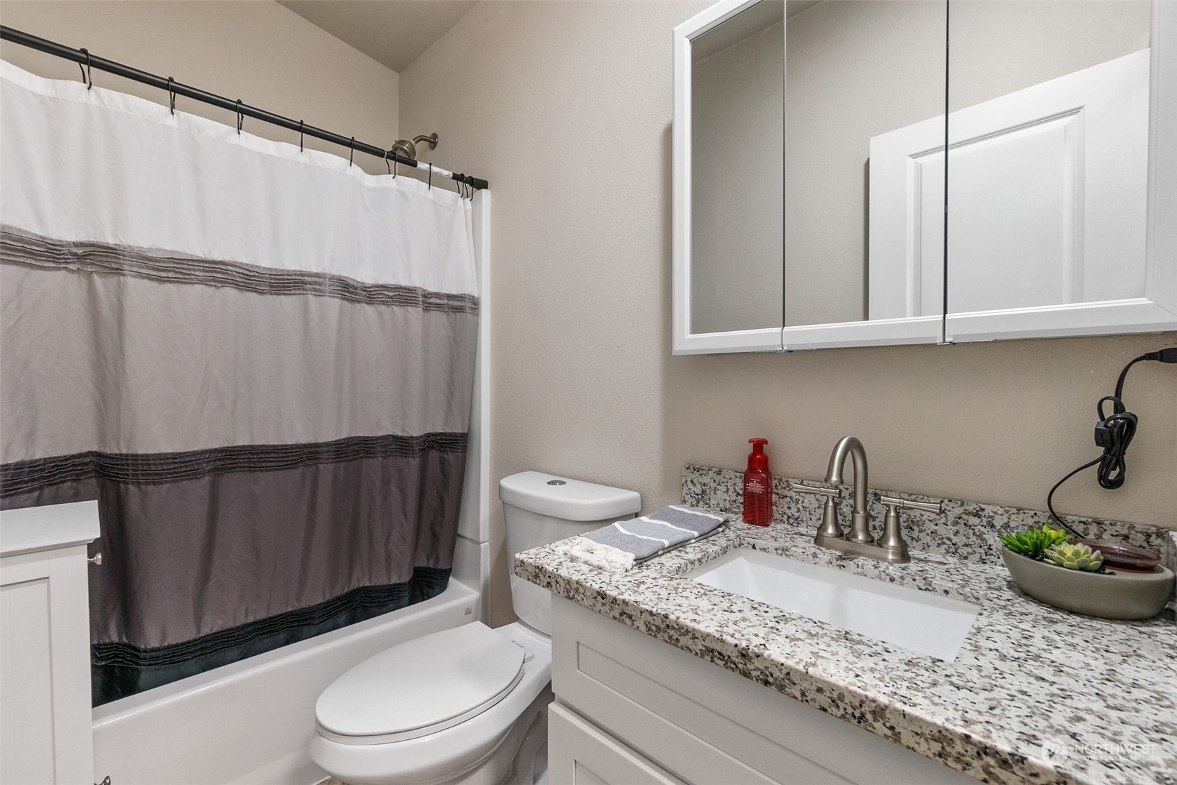 19025 Marble Street Southwest Rochester, WA 98579 - Photo 22 of 26 a bathroom with a granite countertop sink a toilet and bathtub