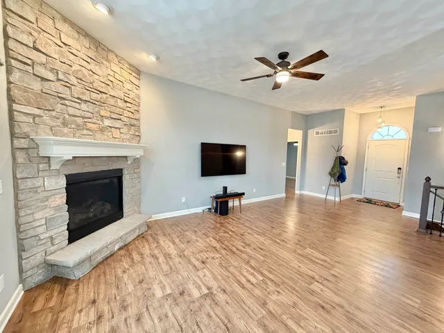 a living room with a flat screen tv and a fireplace