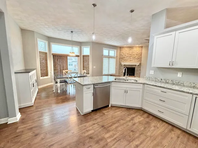 a large white kitchen with sink and white cabinets