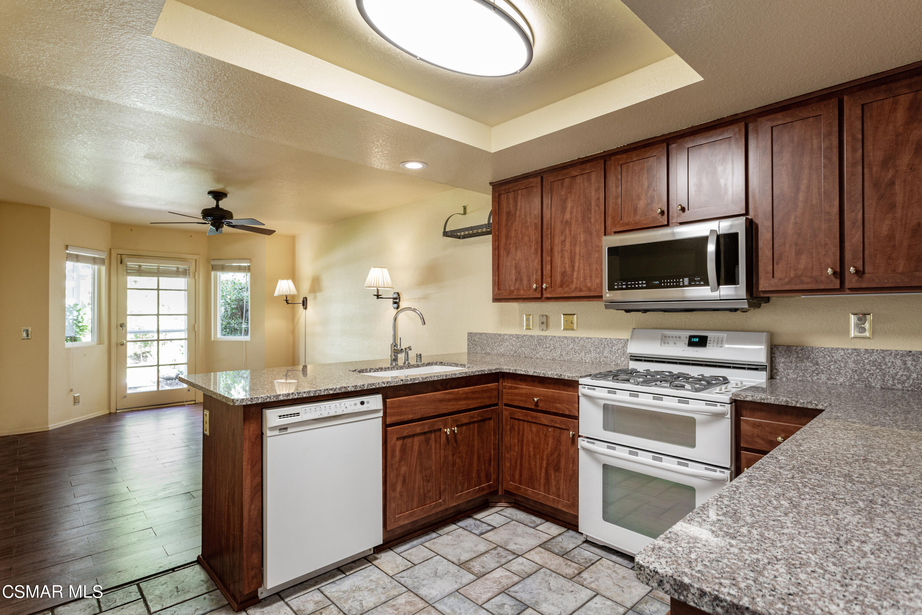 833 Congressional Road Simi Valley, CA 93065 - Photo 14 of 30 a kitchen with stainless steel appliances granite countertop a sink stove and microwave
