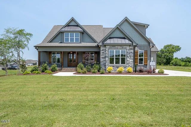 a view of a house with a backyard porch and sitting area