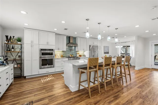 a living room with furniture a flat screen tv and a table
