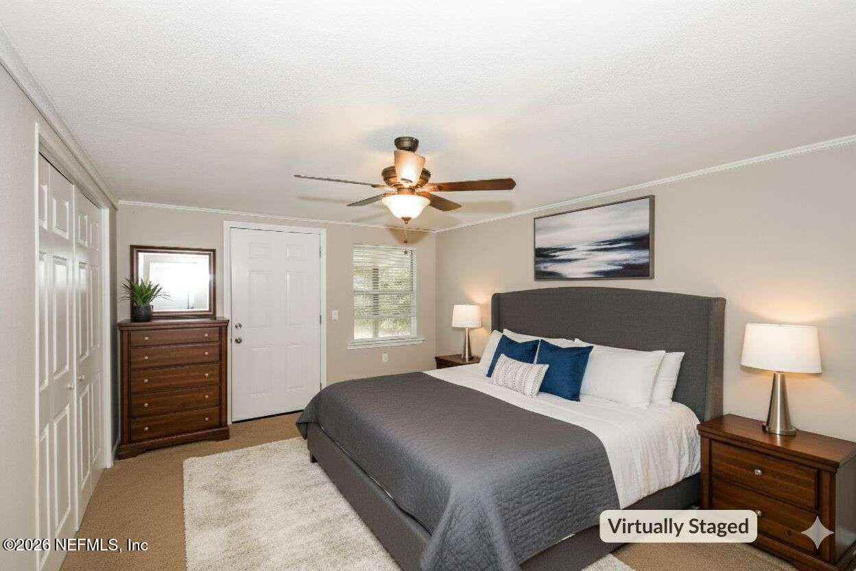 1480 Stimson Street Jacksonville, FL 32205 - Photo 11 of 21 a bedroom with a bed and a chandelier